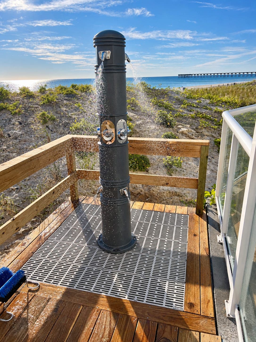 Outdoor shower on a beach deck with the Gulf behind it