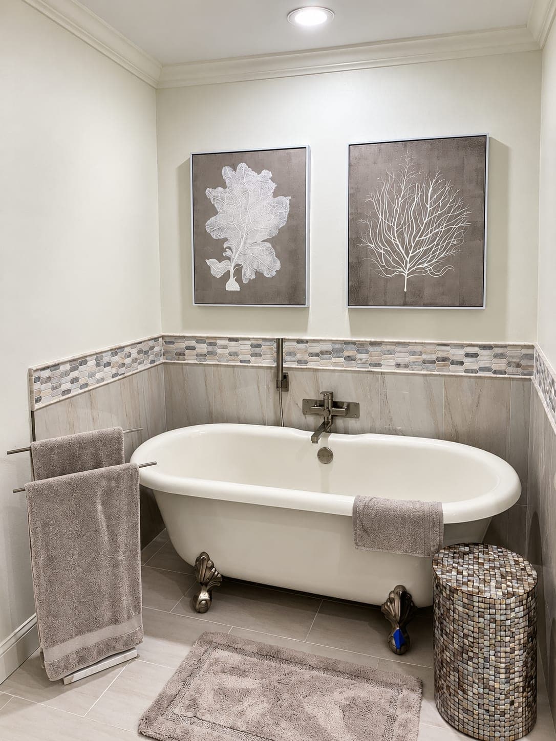 Primary bathroom with a freestanding tub and tiled walls