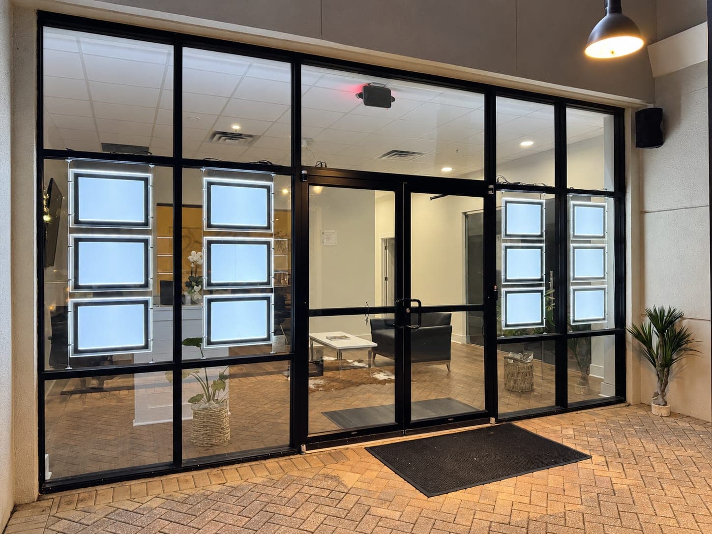 Commercial storefront with a new glass front and lit display windows