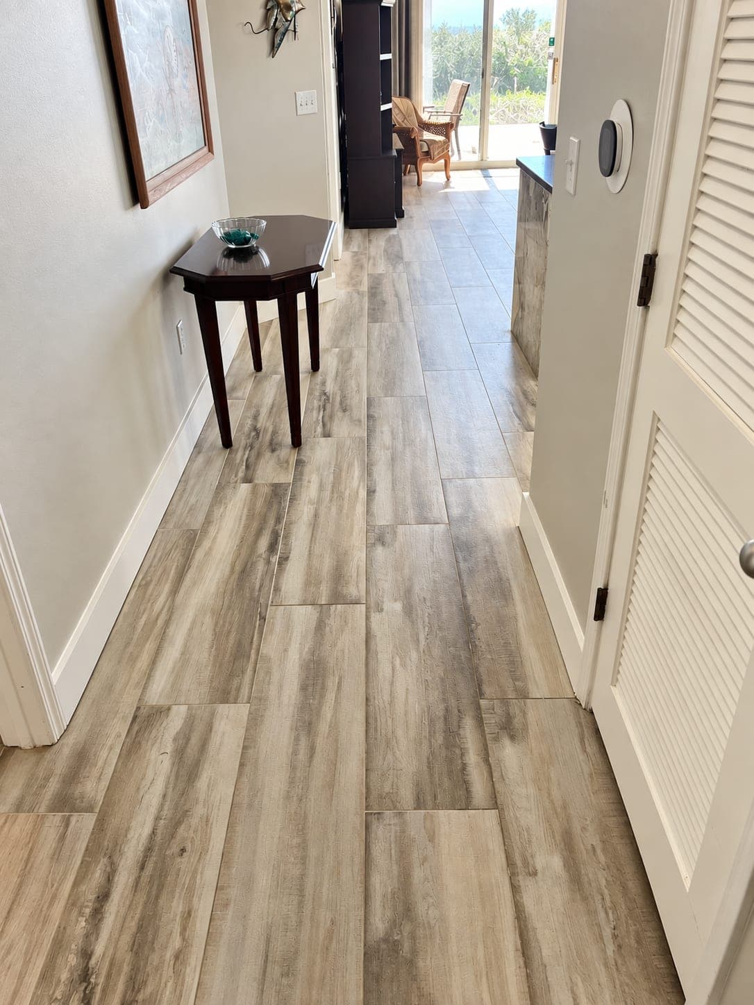 Wood-look porcelain tile floor in a beach condo hallway